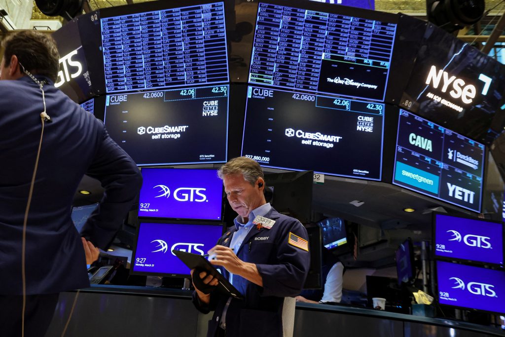 Traders work on the floor of the NYSE in New York
